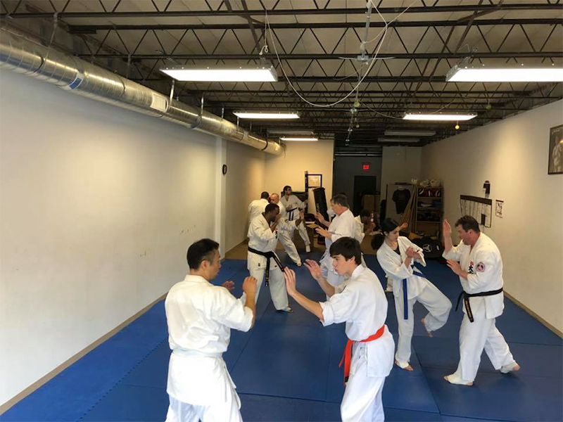Students practice low roundhouse kicks at World Oyama Karate in Atlanta
